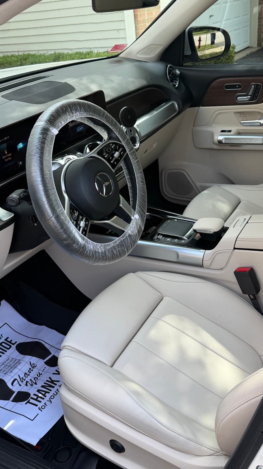 Detailed cream leather front seats and wood trim in a Mercedes GLB