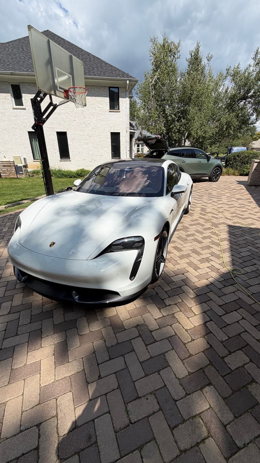 White Porsche Taycan Turbo S detailed on-site in a Naperville, IL driveway