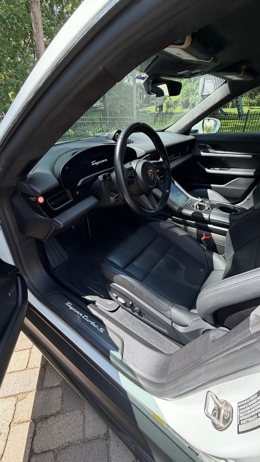 Clean black leather interior and dashboard of a Porsche Taycan